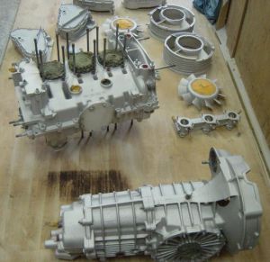 A table with several parts of an engine and gearbox.