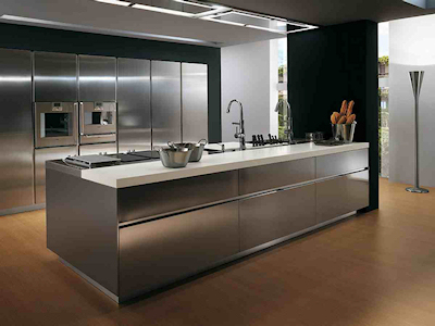 A kitchen with stainless steel cabinets and counters.