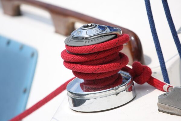 A red rope is tied to the side of a boat.