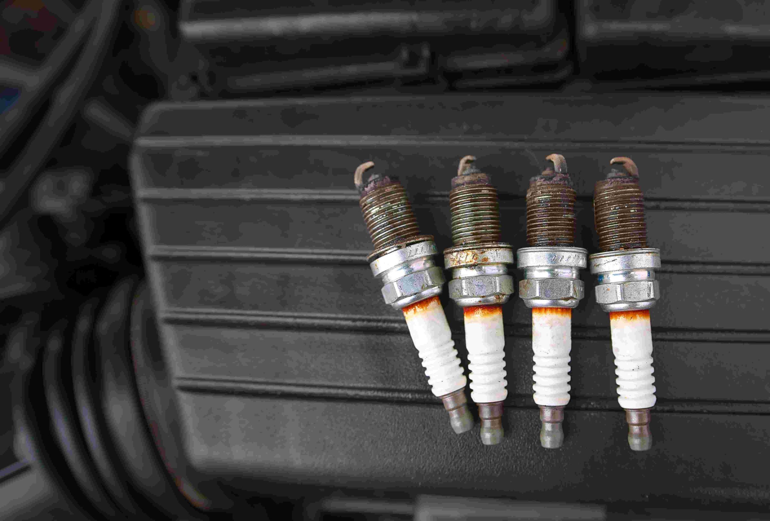 A group of spark plugs sitting on top of the trunk.