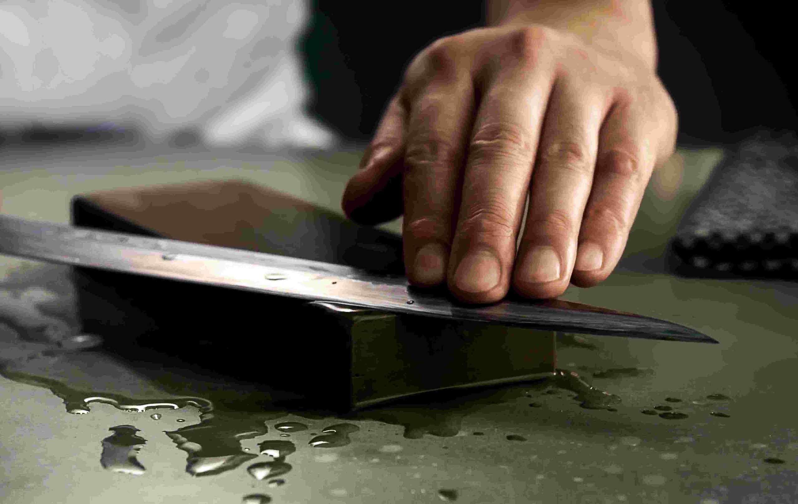 A person using a knife to cut paper