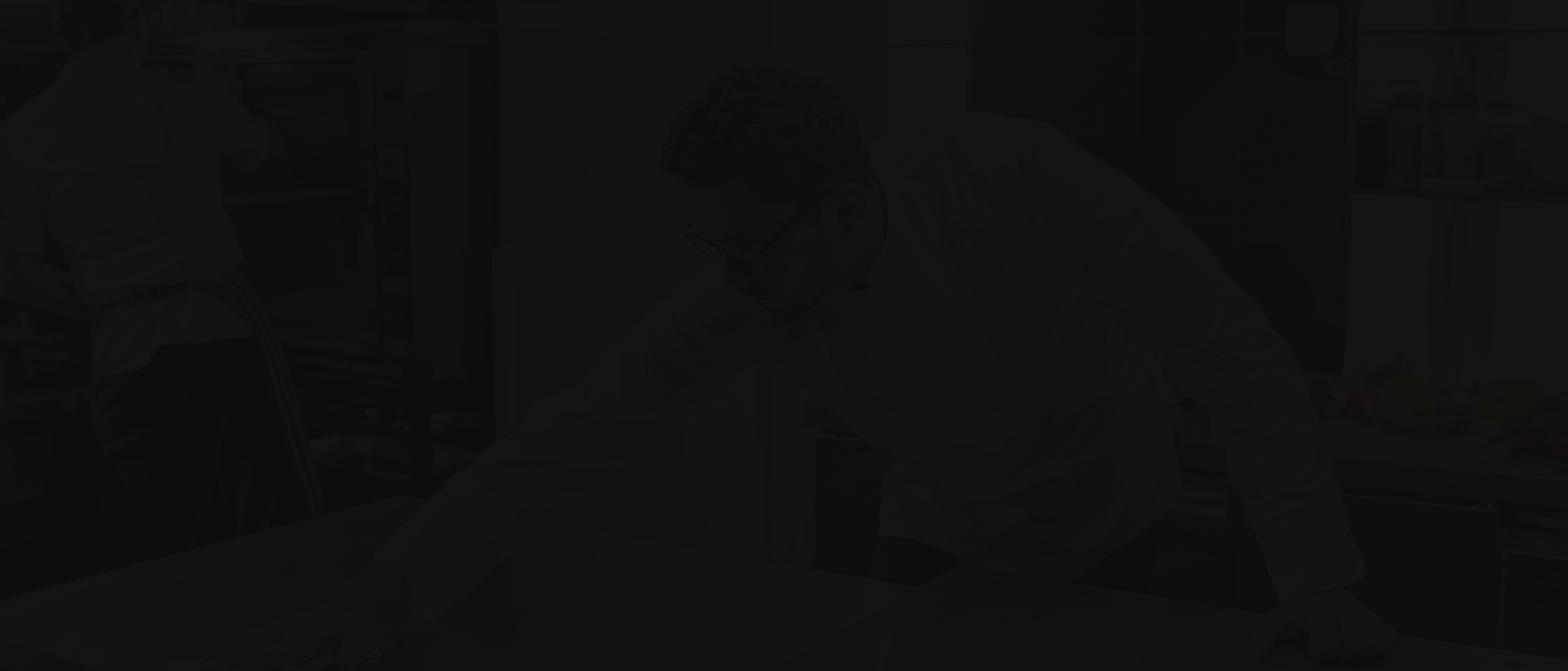 A man sitting in front of a desk.