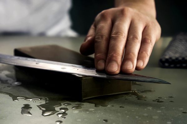 A person using a knife to cut something