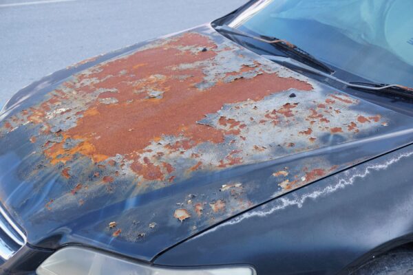 A car that has been painted red and rust.