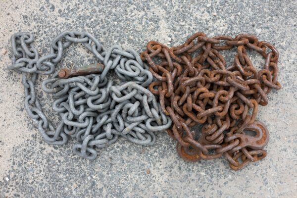 A chain and a metal chain on the ground.