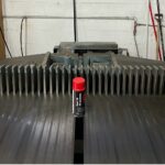 Red-capped spray can on industrial machine.