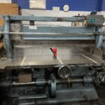 An old industrial metal cutting machine in a workshop.